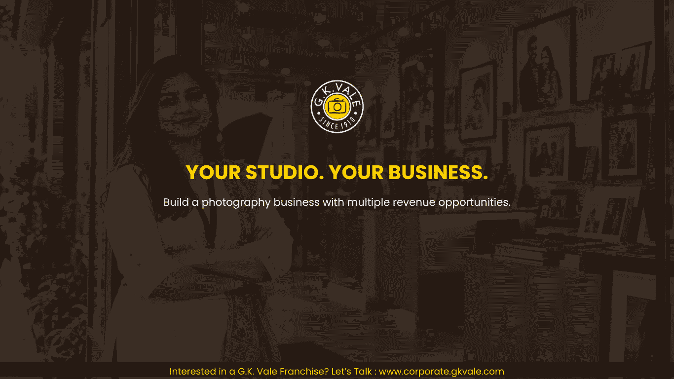 Confident Indian woman standing at the entrance of a professionally established photography studio, representing G.K. Vale franchise ownership and business opportunity.